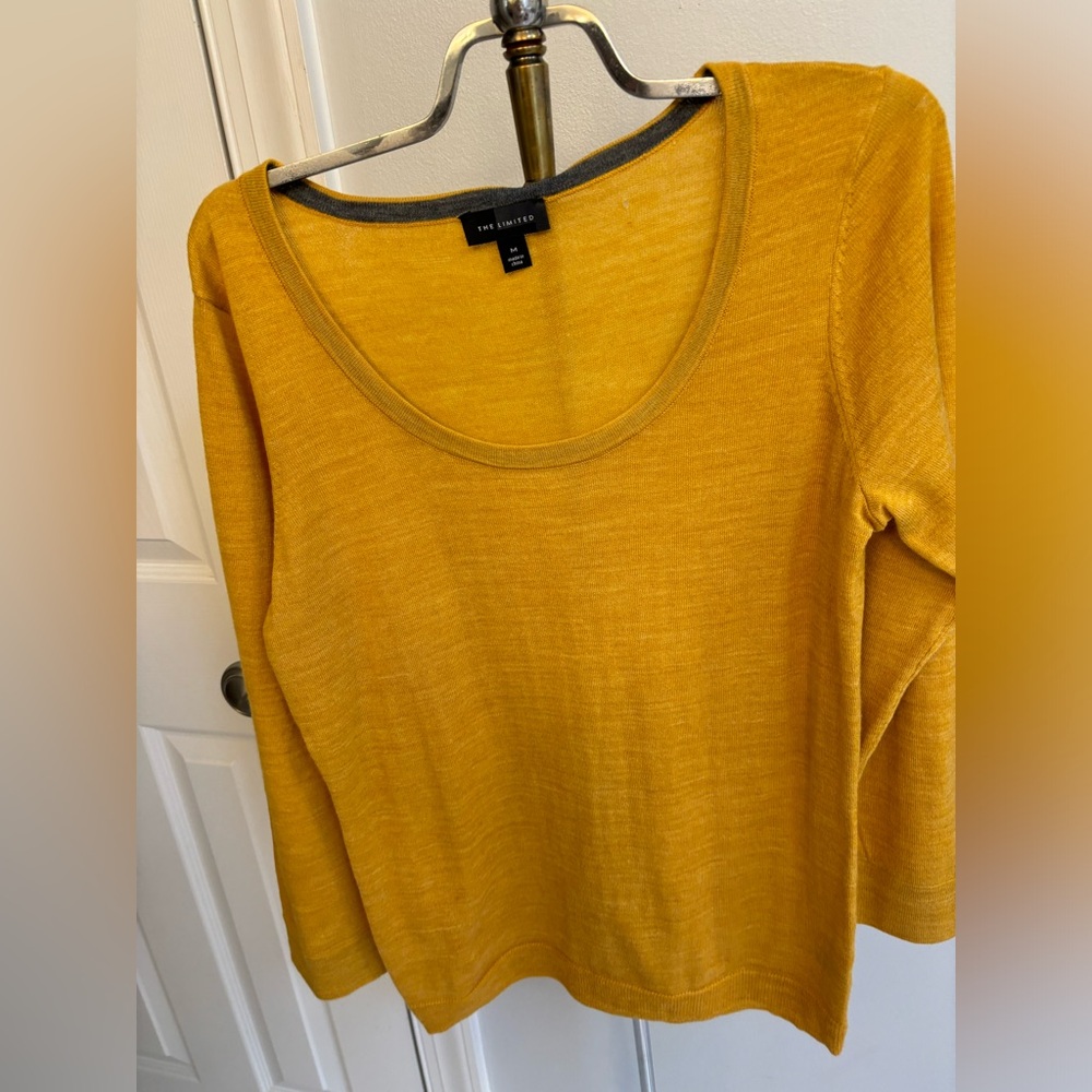 Limited mustard yellow sweater; arms are 3/4 length; two small holes on back